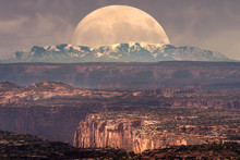 Full Moon At It's Perigee Rising Behind La Sal Mountains In Canyonlands National Park During Sunset