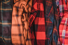 Brightly Colored Checkered Vintage Flannel Shirts Lie Together In A Heap Green Yellow Red Blue Orange