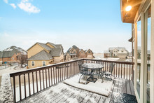 Snowy Deck Overlooking Homes In The Village Blanketed With Snow In Winter