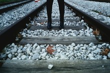 Low Section Of Person Standing On Railroad Stack