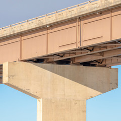 Canvas Print - Square frame View beneath a stringer bridge with massive abutment that supports the deck