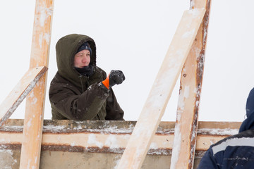 Portrait of a worker in overalls at a construction site