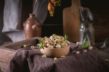 Bowl with pistachios on a rustic background