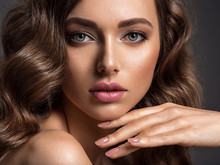 Beautiful Woman With Brown Hair. Beautiful Face Of An Attractive Model With Fashion Makeup.