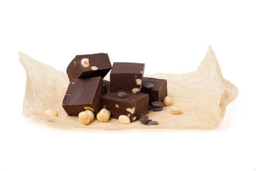 Fudge on a white plate with nuts and chocolate diced