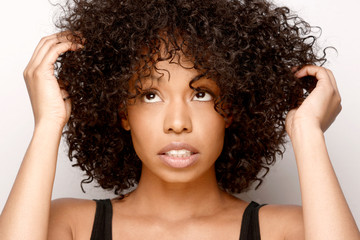 Cute African American woman in need of some natural hair care ideas