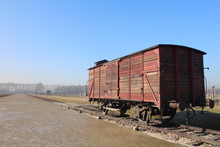 Old Abandoned Freight Train Car On Track Against Blue Sky
