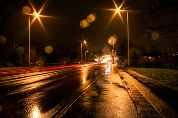 Urban lightpainting. Trained with car lights driving on a boulevard in town. Trained with car lights driving on a boulevard in town. lamplighting with flares on photo.