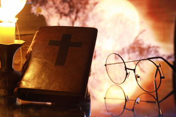 Canvas Print - Vintage glasses on an old retro book on a background of the moon. Reading a book by candlelight. The concept of book thrillers and novels.