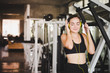 © Nawarit - Beautiful women come to exercise in the gym and are relaxed by listening to music from headphones. She wears a sportswear.