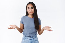 Perplexed And Indecisive, Skeptical Cute Asian Girl Cant Decide, Shrugging With Hands Spread Sideways, Smirk And Look Camera Doubtful, Not Sure, Puzzled To Give Answer, Standing White Background