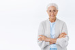 © Cookie Studio - Happy cheerful grandmother waiting family for christmas eve, wear cardigan over blouse get warm and presctiprtion glasses, cross arms chest, casual pose, smiling joyfully taking care of grandkids