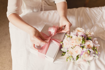 the bride opens her gift on the wedding day