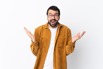 Wall Mural - Caucasian handsome man with beard wearing a corduroy jacket over isolated white background with shocked facial expression