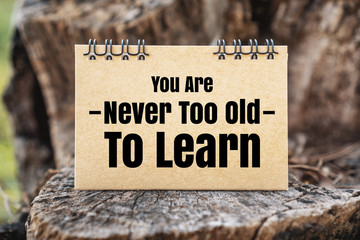 Wall Mural - You Are Never Too Old To Learn. Rustic Paper on Wood.