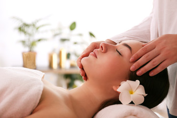 Portrait young beautiful woman lying on the massage table in spa wellness salon. Beauty and health procedures for women concept. Close up, copy space, background.