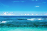 Fototapeta Na sufit - Beach and beautiful tropical sea. Caribbean summer sea with blue water. White clouds on a blue sky over summer sea.  Tropical sea relax.