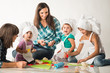 © YouraPechkin - Charming young mother shows a master class to her cheerful children on the preparation of pastries and cookies. Concept of teaching children to a healthy lifestyle and work since childhood