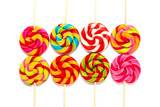 Fototapeta Tęcza - Round multi-colored lollipops on a wooden stick