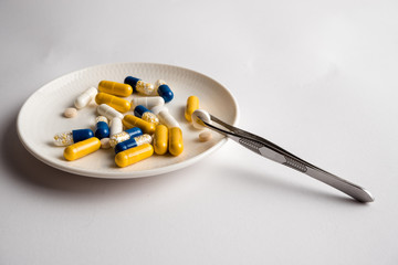 Different tablets, pills, medications drugs on white background