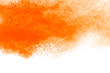 Abstract orange powder explosion. Closeup of orange dust particle splash isolated on white background.