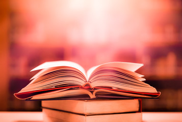 Poster - An ancient book that opens with magic, the magic light in the darkness on the wooden table, by the bright light shining down as the power to search for knowledge, religion and background