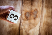 Number 3 - A Hand Holding A White Block With Number Three Over Vintage Wooden Table