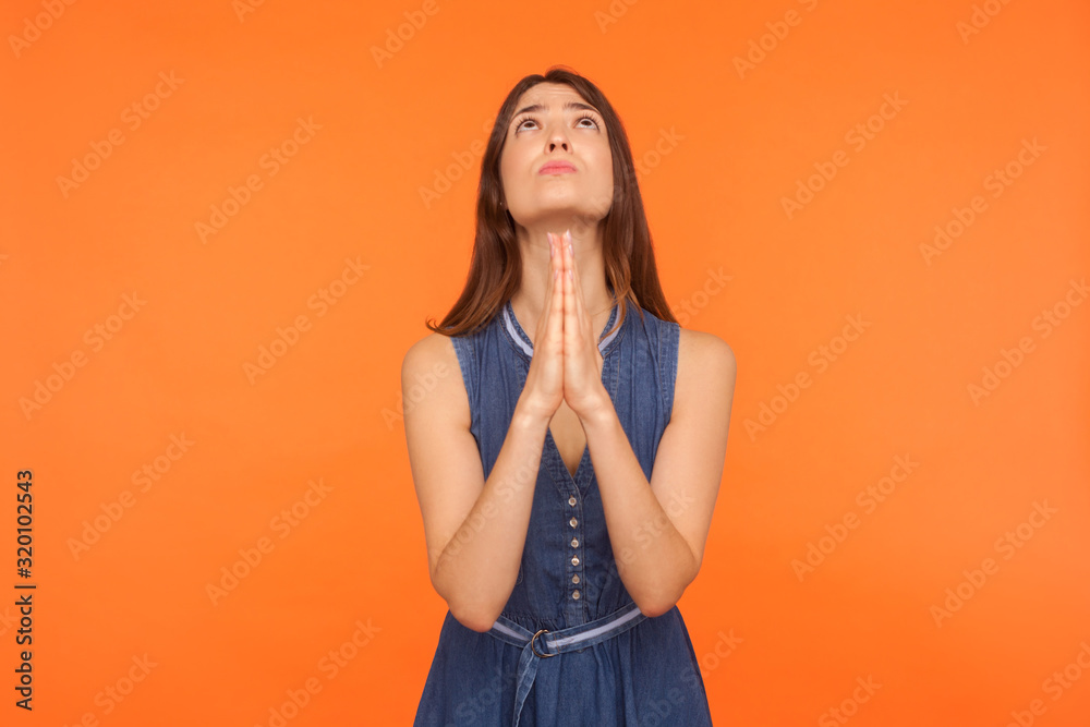 Please, God I'm begging! Upset brunette woman holding cupped hands and ...