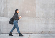 © Mego-studio - Asian woman walking and holding a cup of coffee.