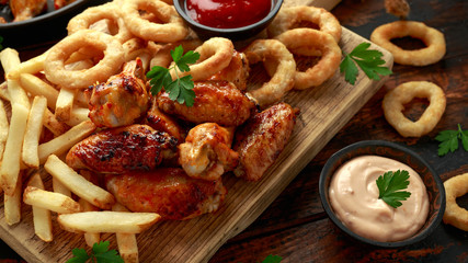 Wall Mural - Fried Chicken wings with onion rings, french fries and dipping sauce. take away food.