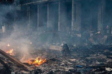 burned building and barricades at the maidan square in kyiv, ukraine during anti government protests