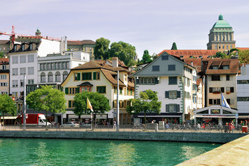 Wall Mural - Zurich, Switzerland - September 2, 2016: University of Zurich, Switzerland. Seen at Limmat River embankment. People on the background