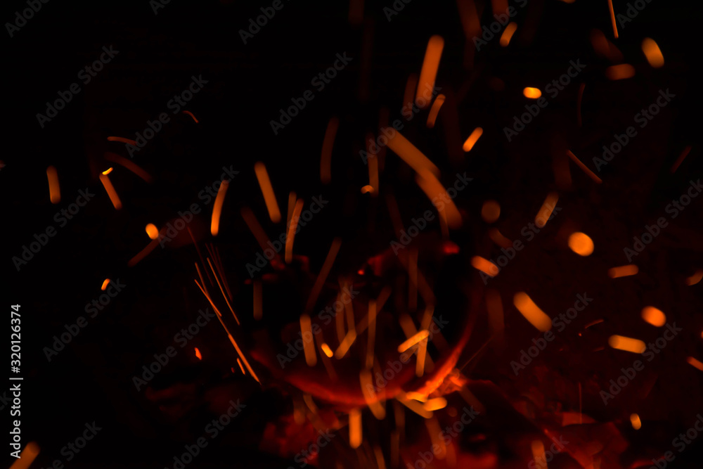Close-Up Of Sparks At Night - obrazy, fototapety, plakaty 