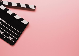 Clapboard on a pink background, movie concept