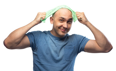 Wall Mural - Portrait of young bald man in blue tee shirt with towel