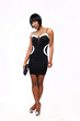 Attractive African American woman wearing a sexy back dress standing and looking at the camera