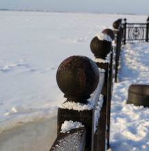 Close-up Of Iron Fence On Shore River