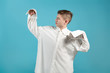 © Вячеслав Думчев - a young man in an oversized white shirt shows that his shirt is too big for him