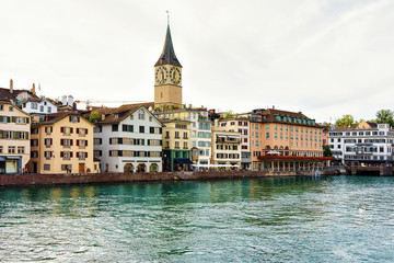 Poster - St Peter Church at Limmat River quay in the city center of Zurich, Switzerland. People on the background