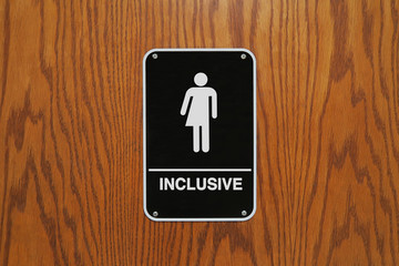 Gender neutral restroom sign that says, INCLUSIVE.