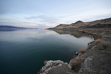 Wall Mural - Rock formations and reflections of Pyramid Lake, Nevada on clear tranquil winter afternoon.