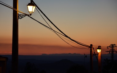 two street lamps at sunset