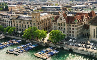 Wall Mural - Boats at Post office and Stadthaus at Limmat River in Zurich old town, Switzerland. People on the background