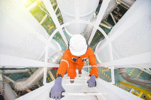 Fotografía Production operator climb up to oil and gas process plant to observer gas dehydration processing at offshore oil and gas central processing platform