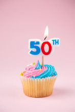 50th Candle On A Cupcake On A Pink Background