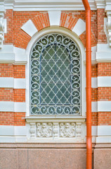 Canvas Print - Close-up of ancient vintage arch window with cast iron white lattice, pattern