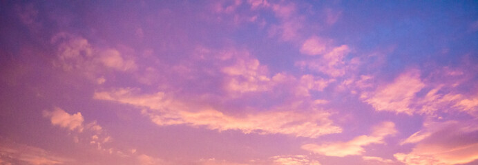 beautiful cloudy sunset sky with orange, purple, pink, and magenta hue; with vibrant colors. abstrac