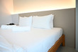 © kathayut - White bed and pillows in a modern style bedroom