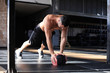 © ty - Fit and muscular man exercising with medicine ball at gym.