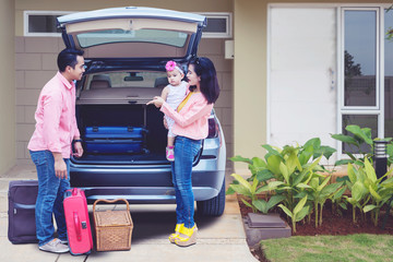 Poster - Asian family preparing suitcase to the car